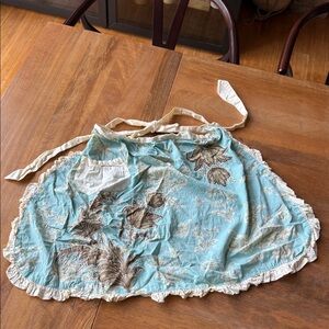 Anthropologie Retro Floral Light Blue Women's Apron with embroidery detail.